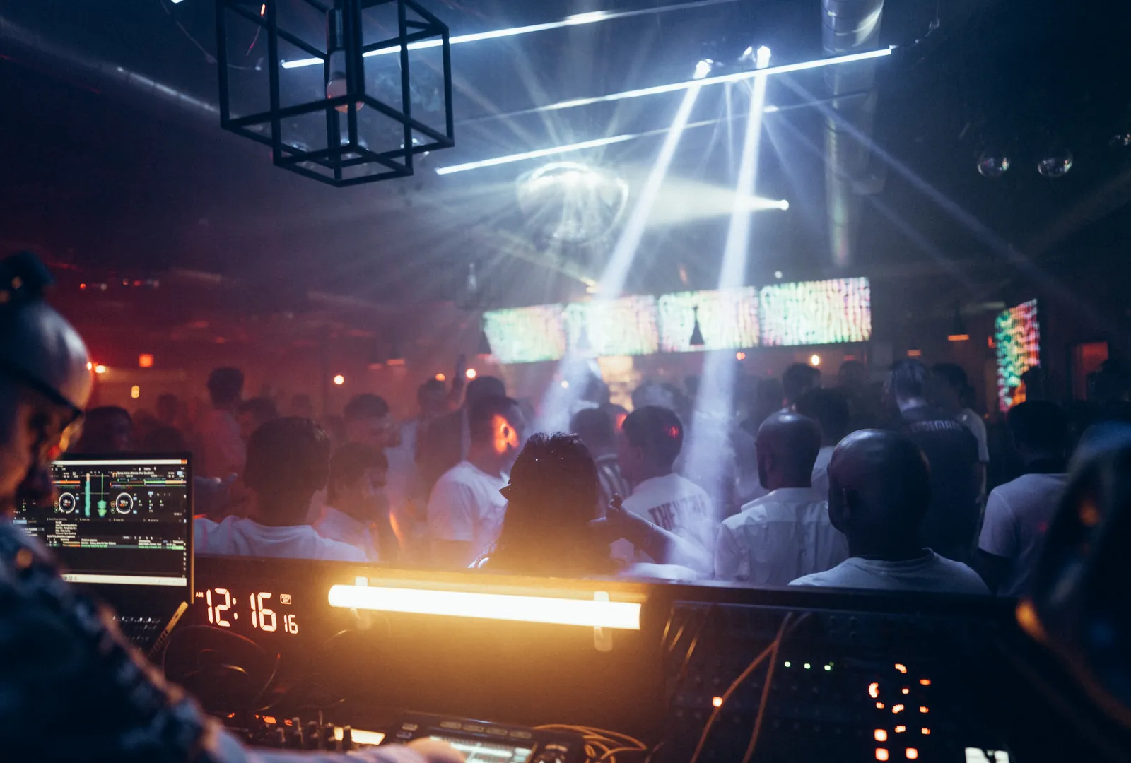 A DJ booth overlooking guests and music at Time Out On Pine
