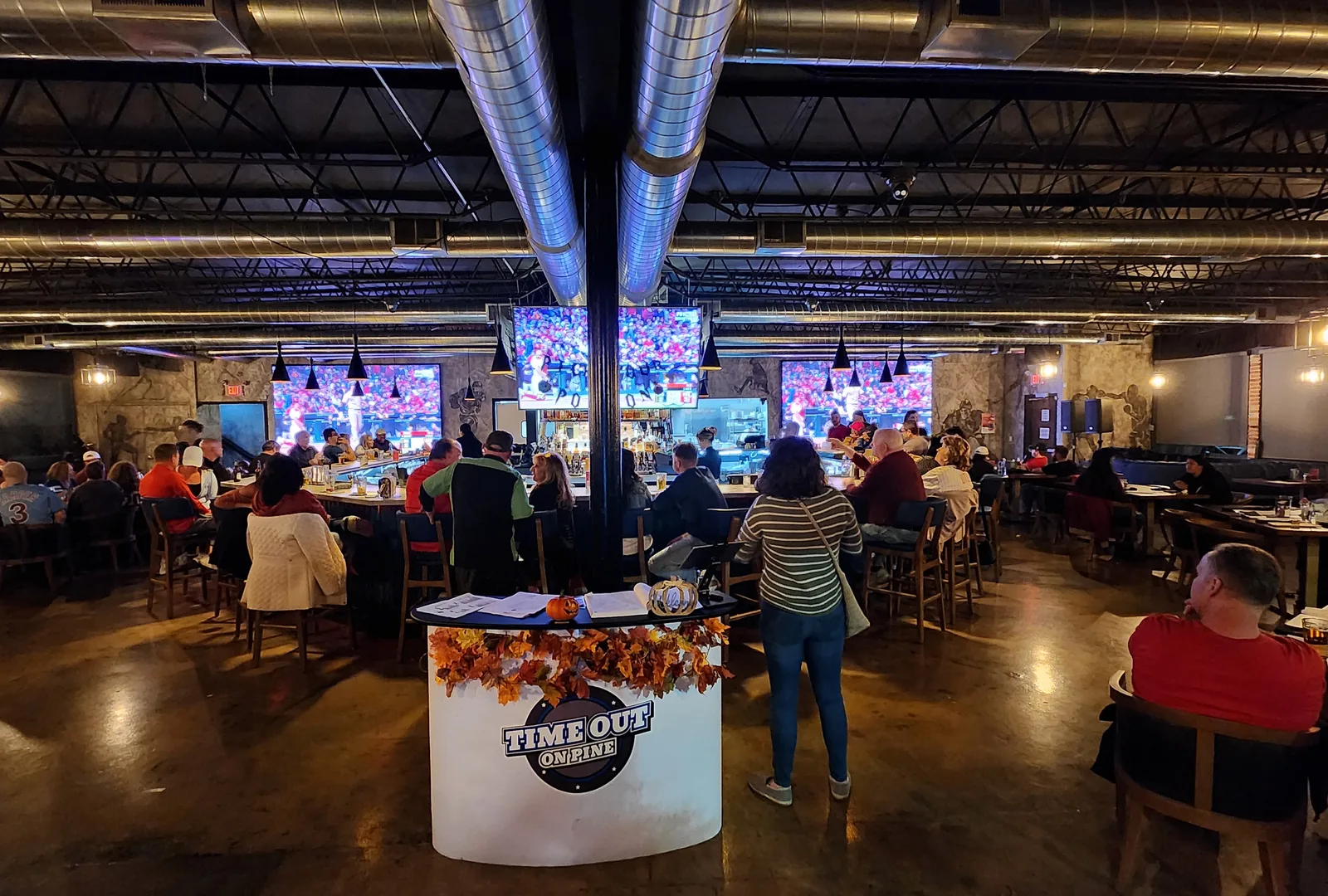 Guests watching sports on the big screens at Time Out On Pine